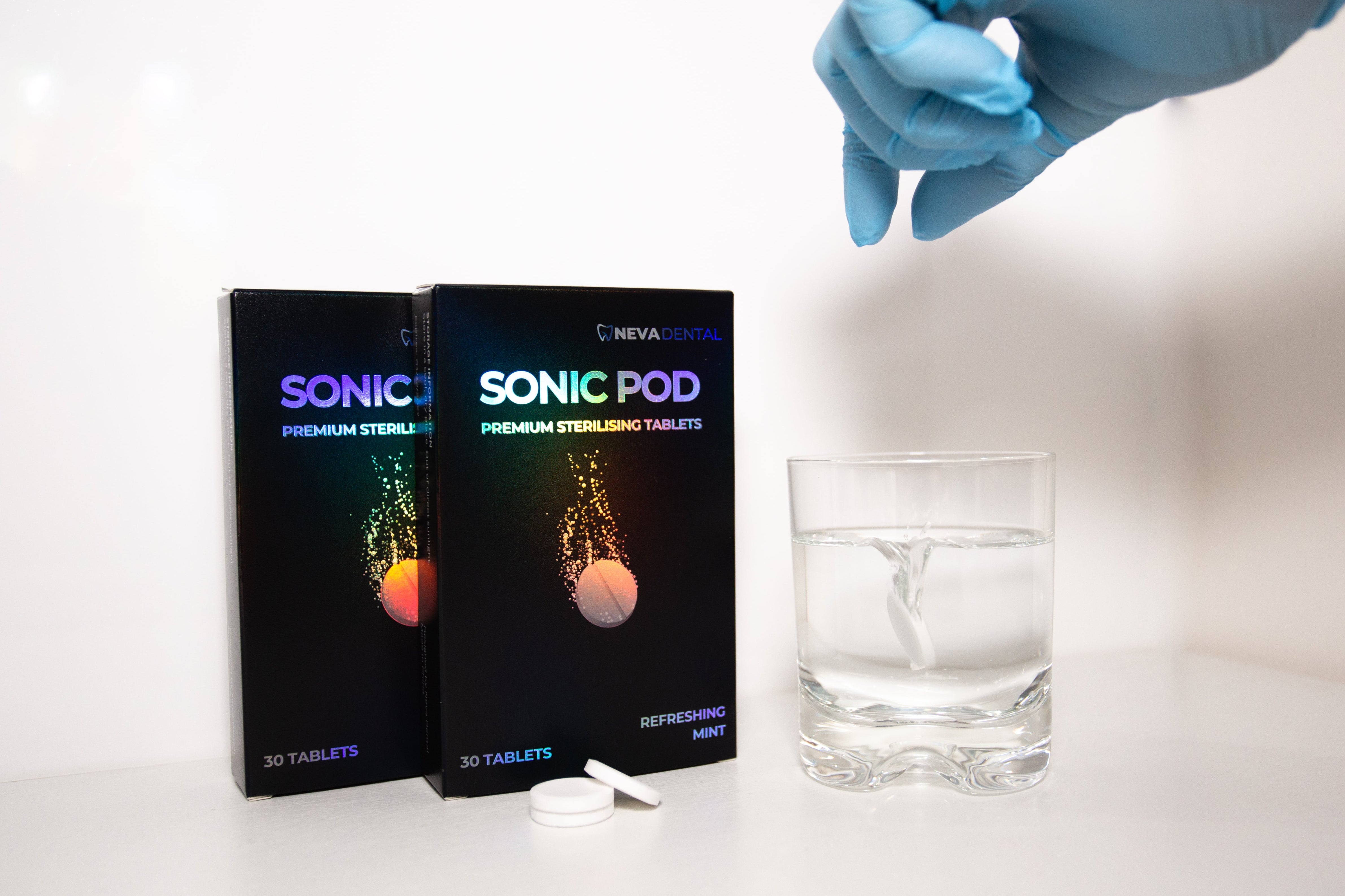 Neva_dental_sonic_pod_sterilising-tablets_glove_dropping_into_water
